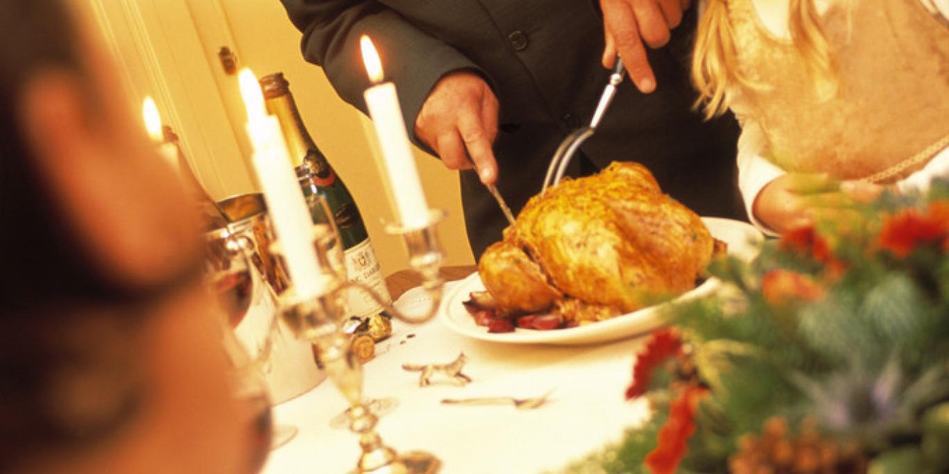 Man Carving Turkey at Christmas Dinner