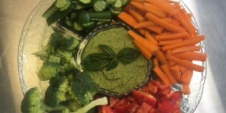 Edamame and pea hummus with a selection of fresh vegetables for dipping.